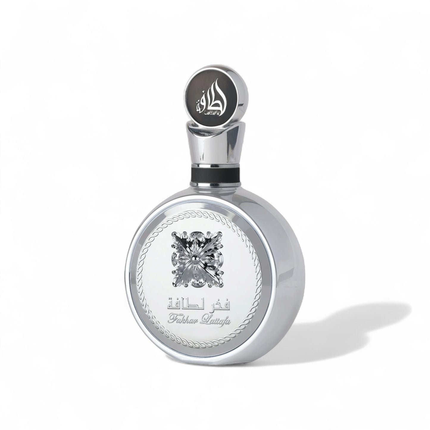 Orijent Parfimerija Fakhar Lattafa silver round perfume bottle with ornate gold cap and crystal-like emblem.